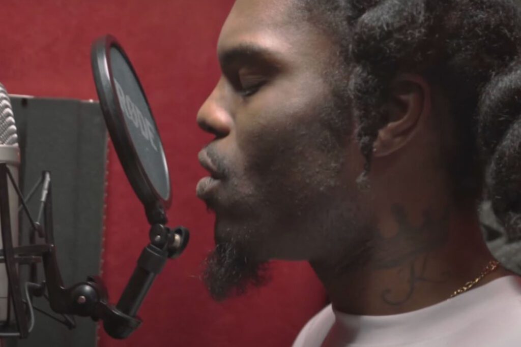 A Key Changes artist recording vocals in a studio