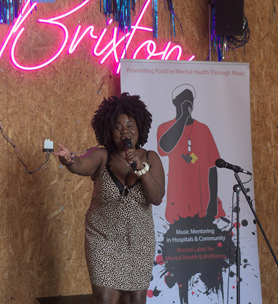 A Key Changes artist performing on stage at a community event