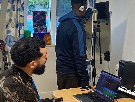 A participant recording with a Key Changes music producer in a hospital room